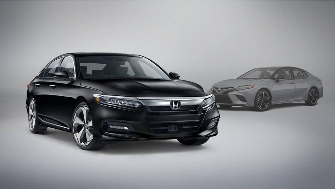 Front passenger-side view of the 2020 Honda Accord Touring 2.0T parked next to competitor vehicle Toyota Camry.